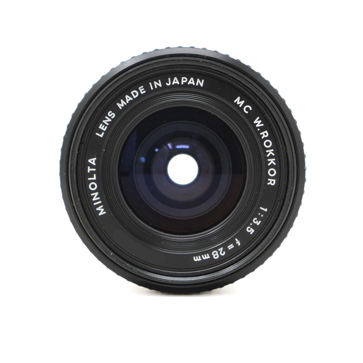Minolta camera lens with 'Made in Japan' text on a white background