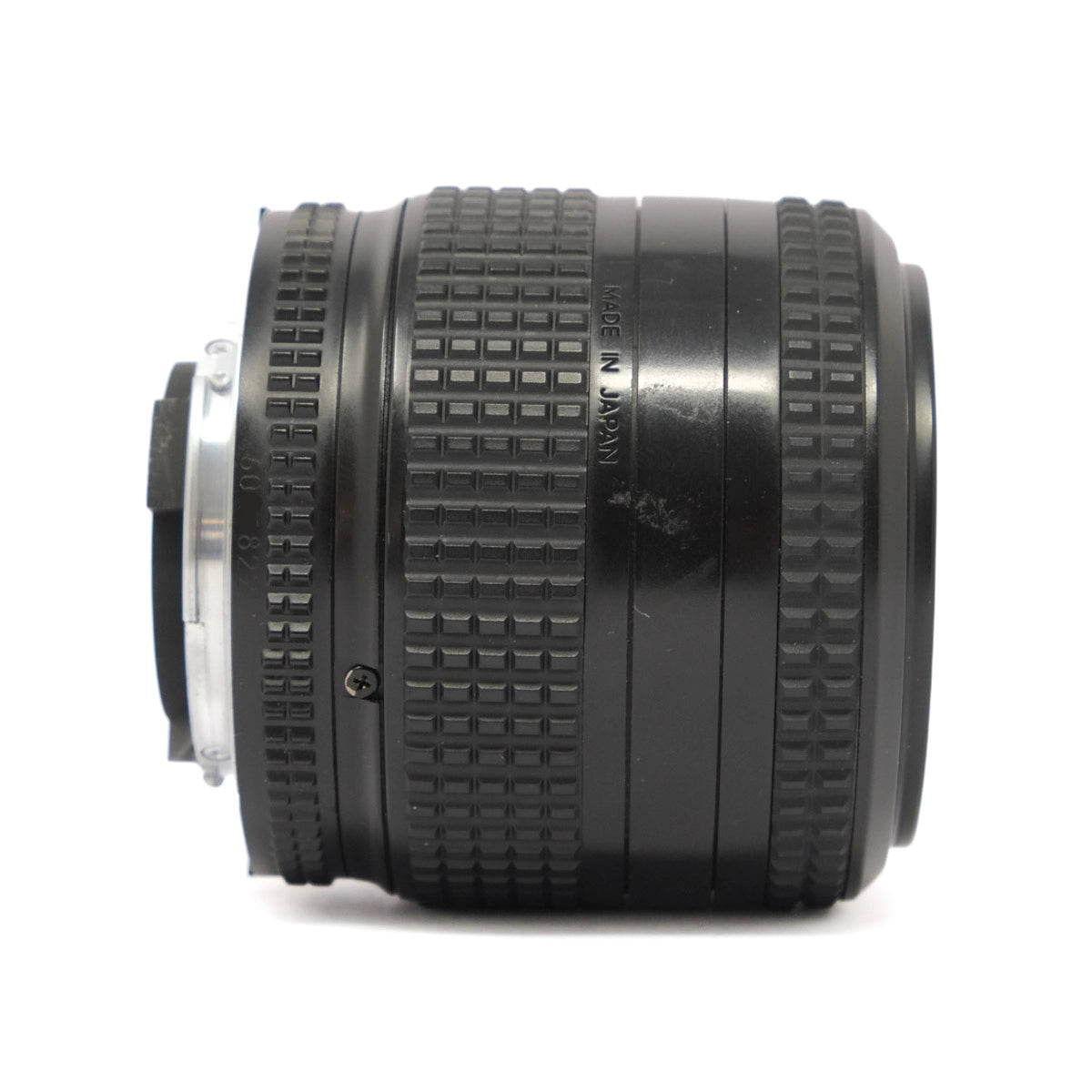 Camera lens with textured design on a white background