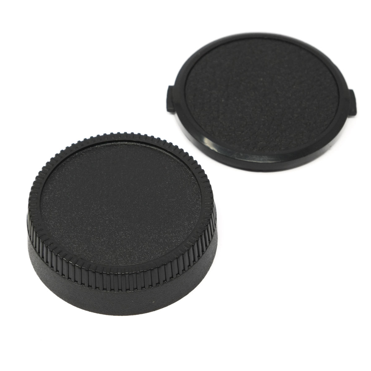 Two black camera lens caps on a white background