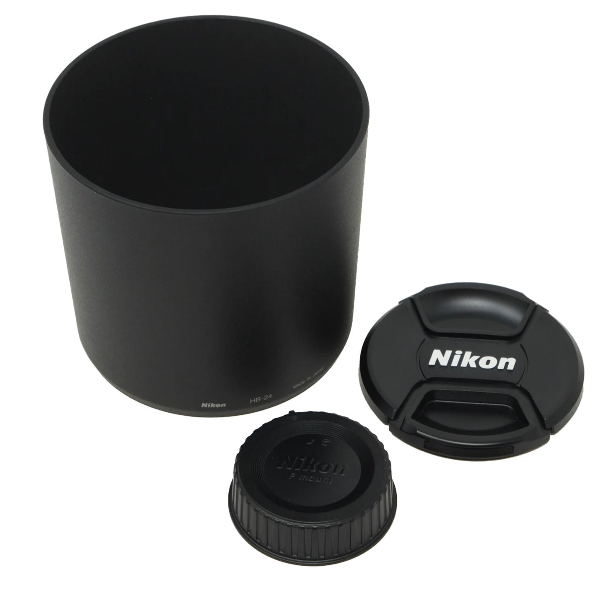 A black Nikon lens filter hood with its matching cap and threaded lid, displayed on a clean white background.