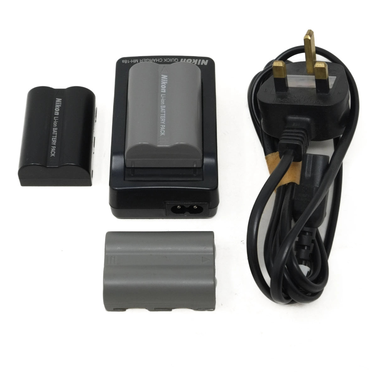 Nikon camera battery and charger set on a white background