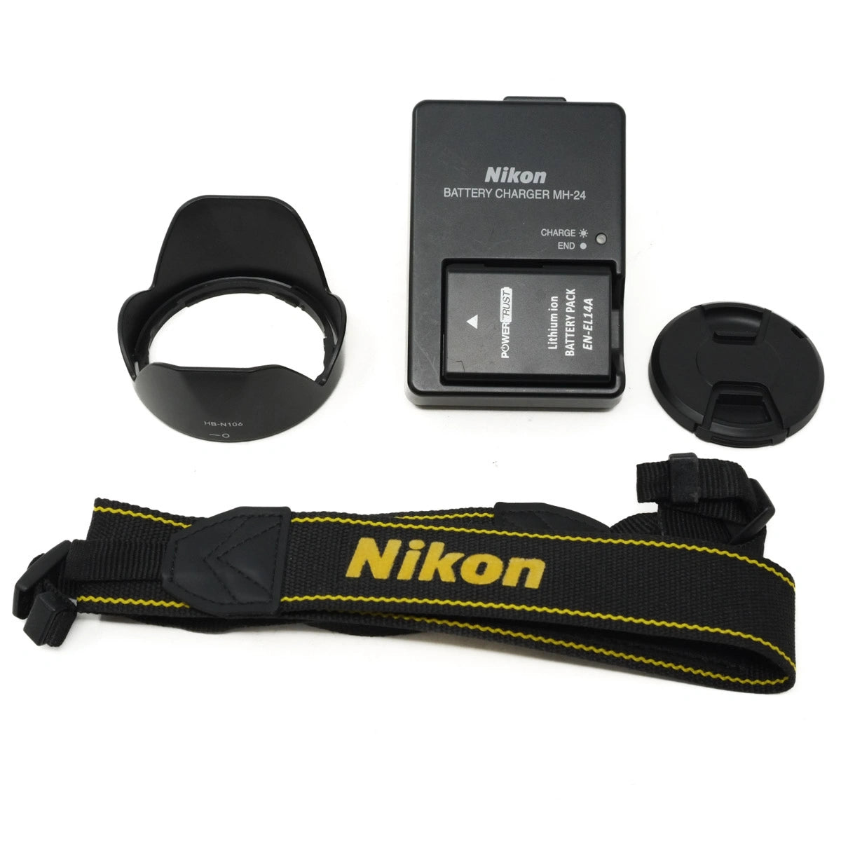 Nikon camera accessories including battery charger, lens hood, lens cap and strap on a white background