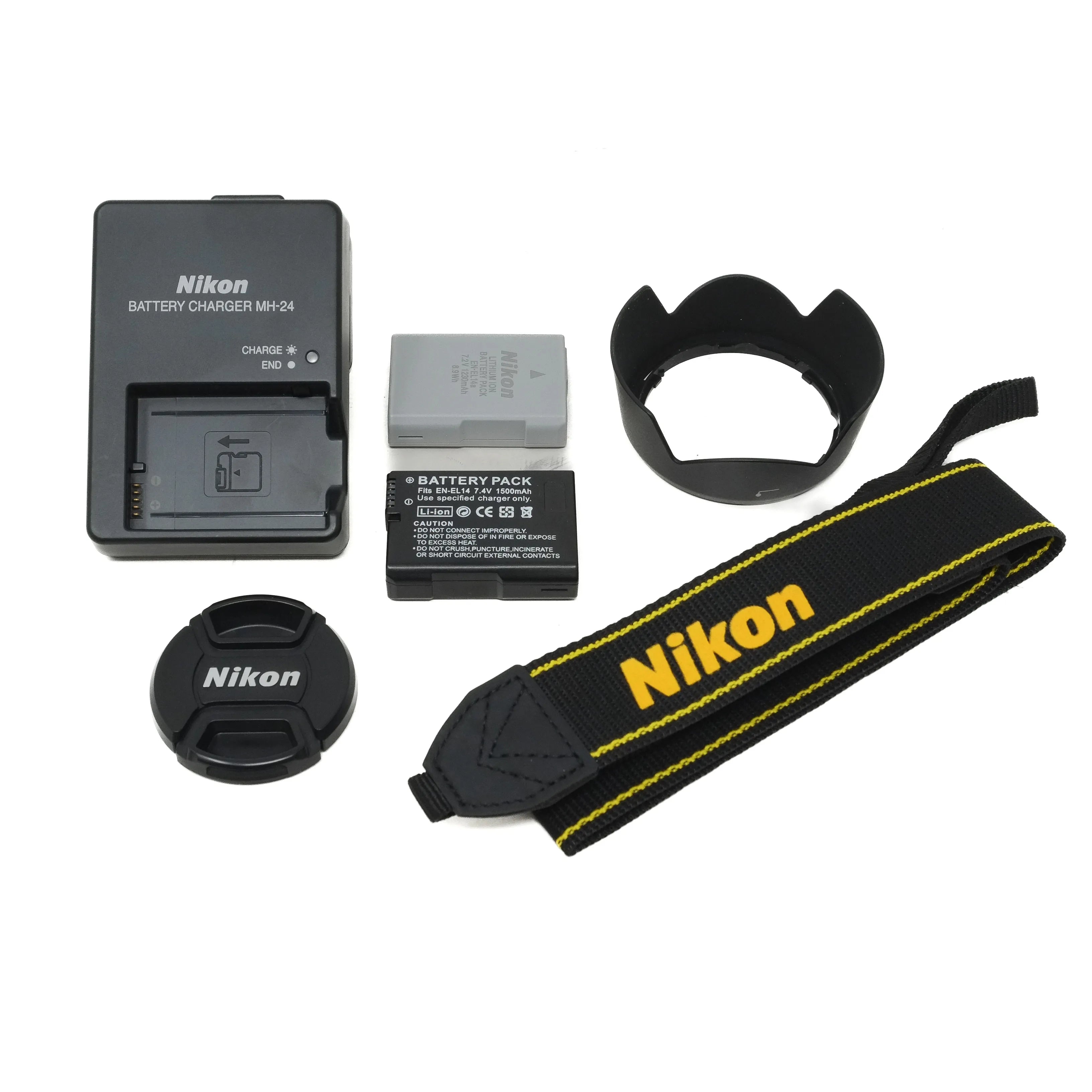 Nikon camera accessories including batteries, charger, strap, and lens cap on a white background