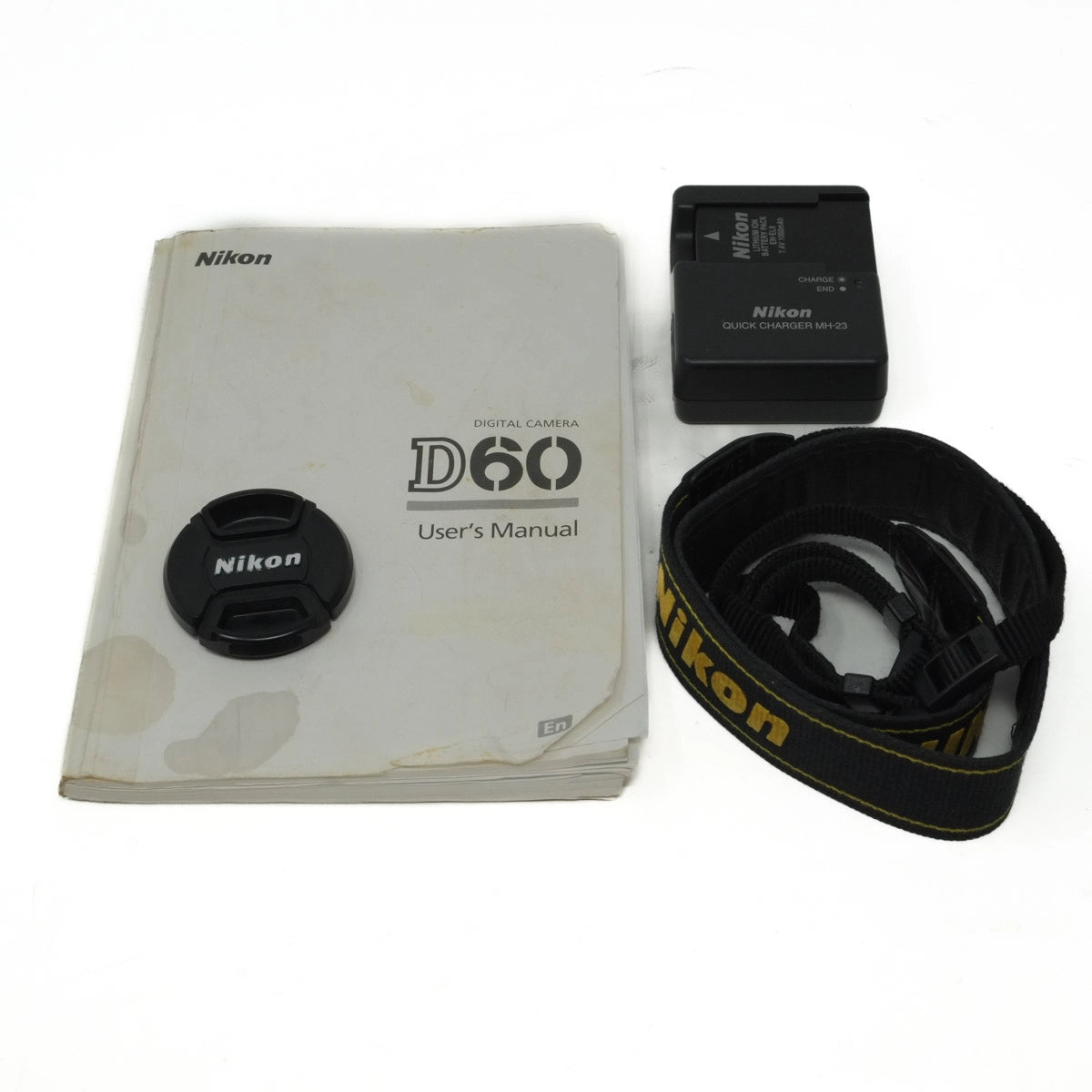 Used Nikon D60 DSLR camera with 18-55mm VR lens - front cap, instructions, strap, battery and charger