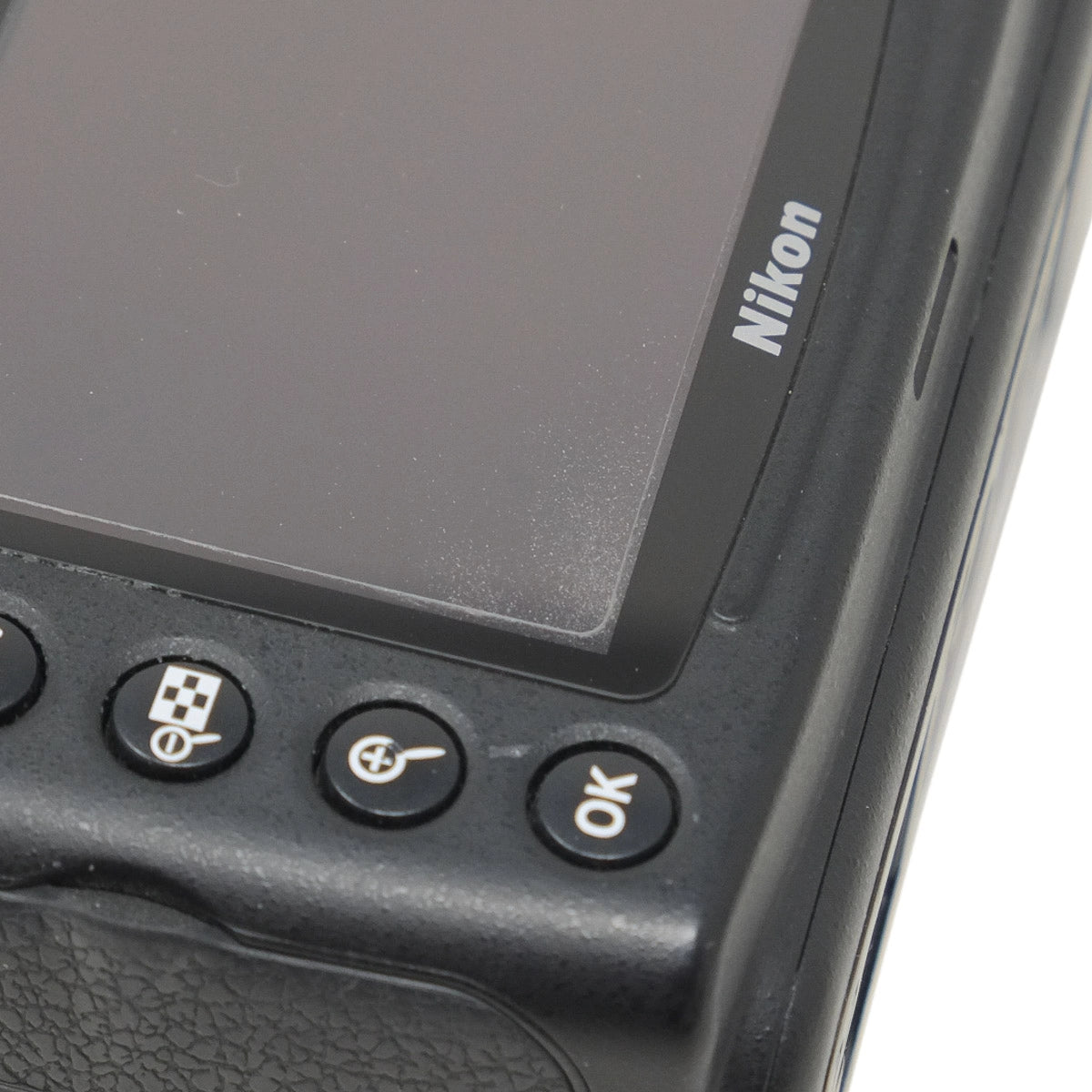 Nikon camera control panel with buttons and screen on a white background