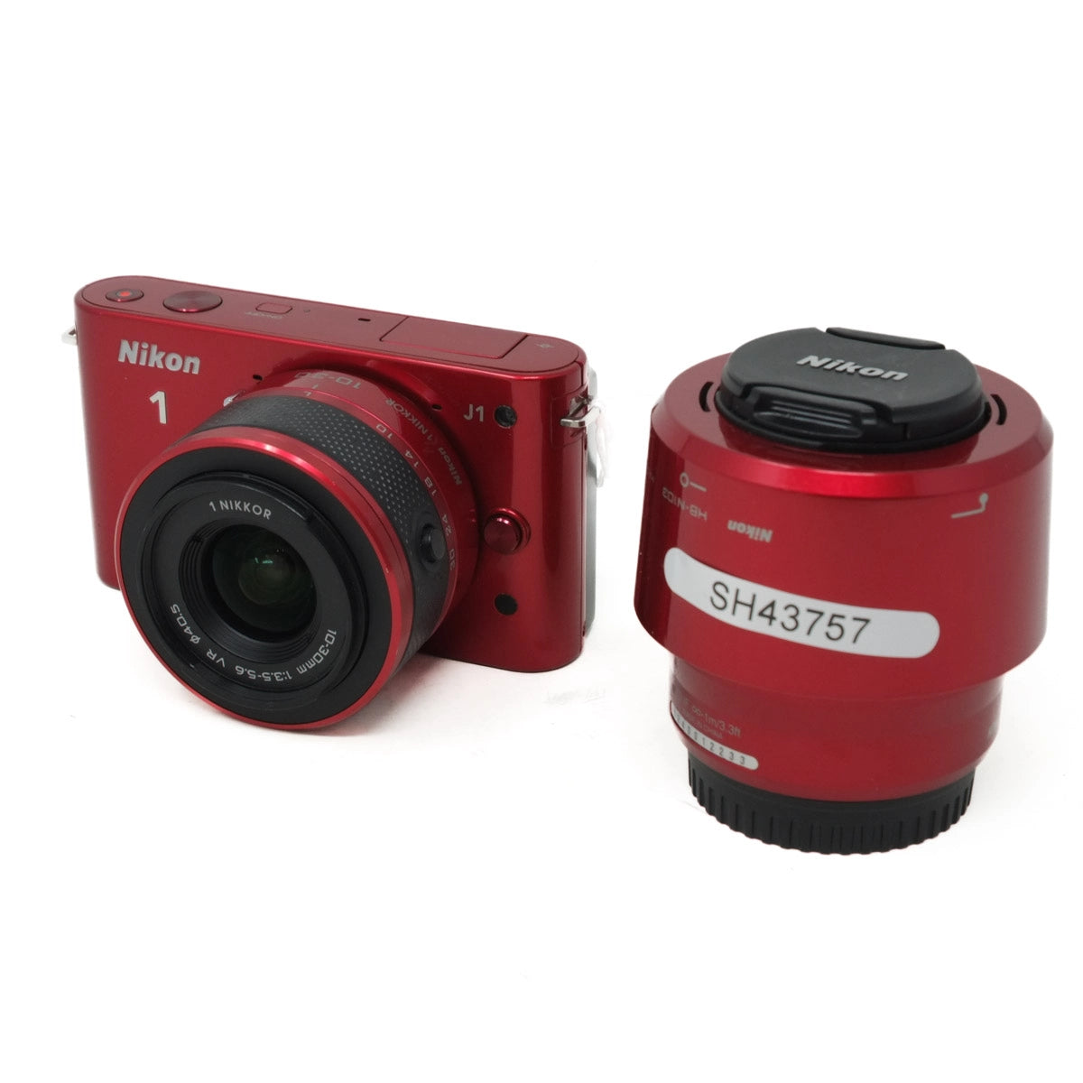 Red Nikon camera and lens on a white background