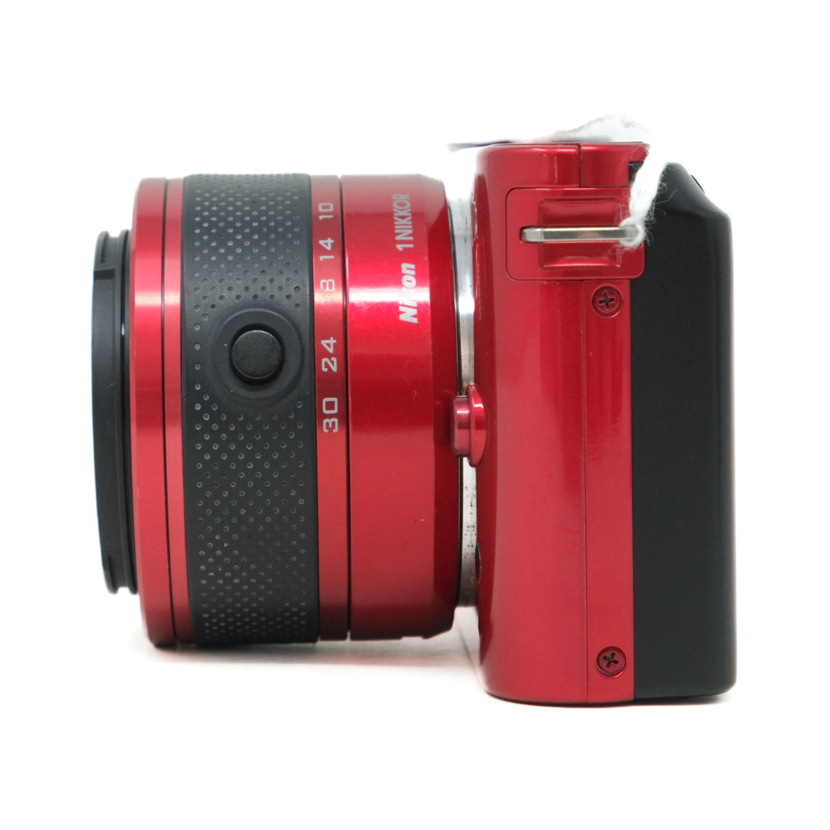 Red camera lens with focus ring on a white background