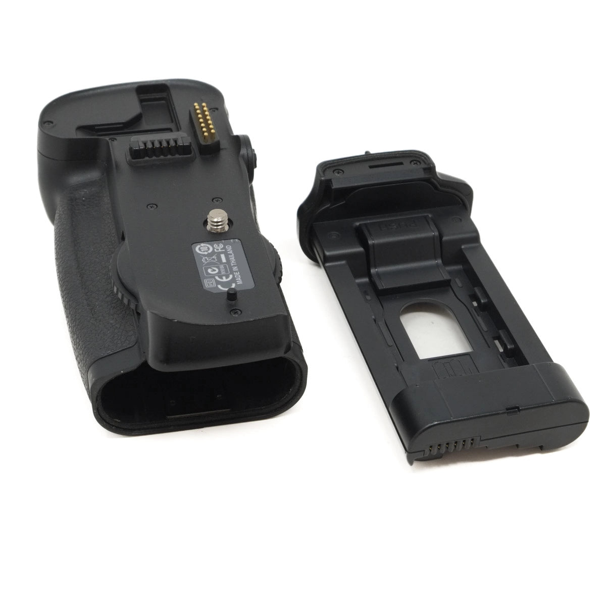 Two black camera battery grips on a white background