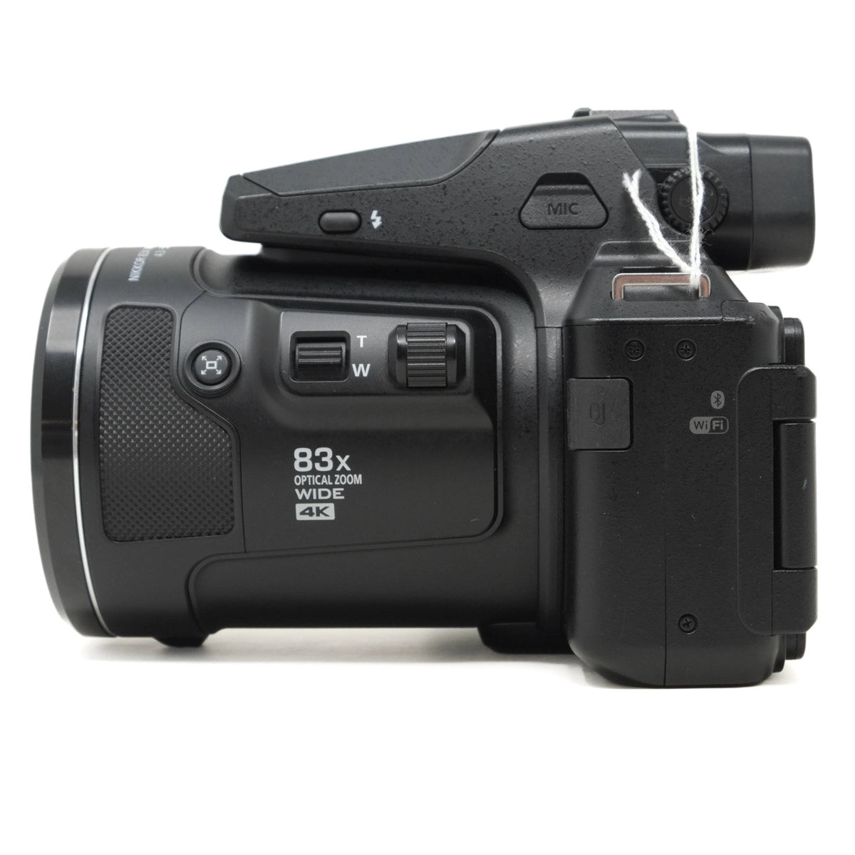 Black digital camera with various controls on a white background