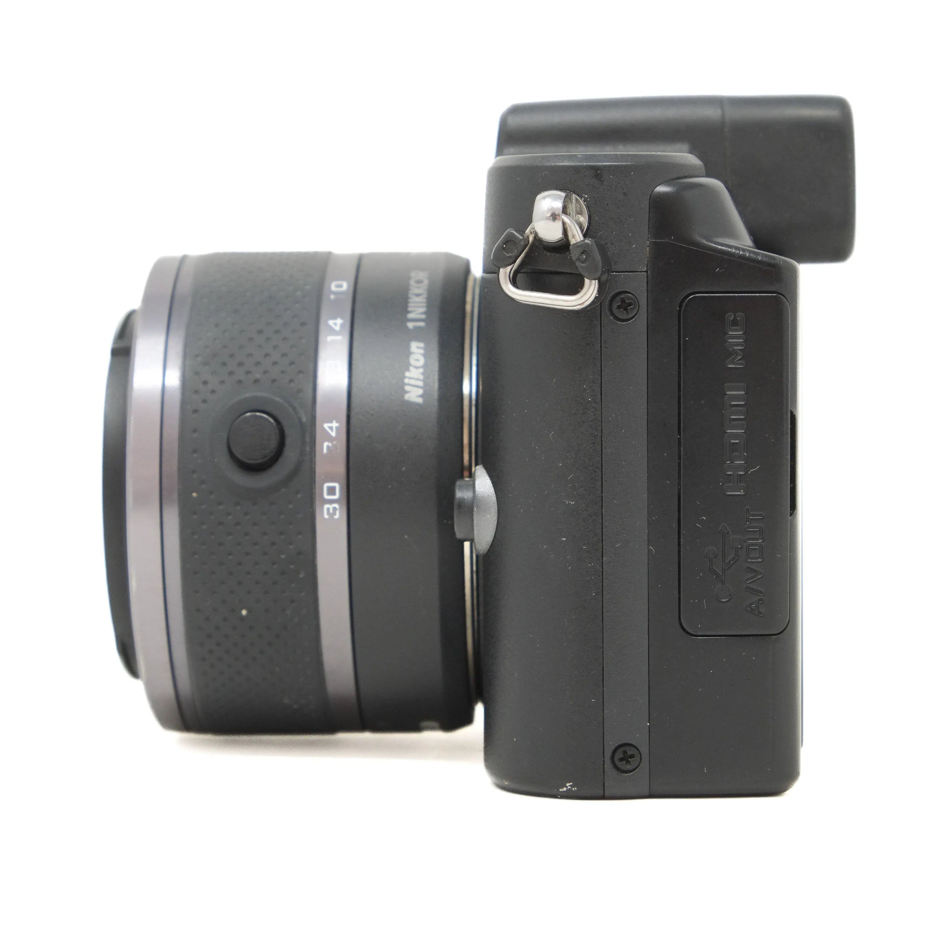 Side view of a digital camera with lens and control buttons on a white background