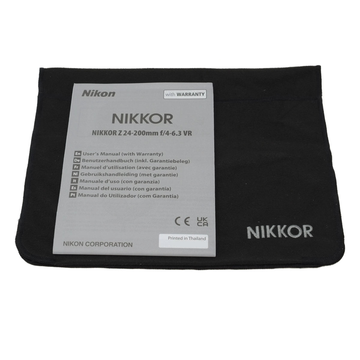 Nikon Nikkor camera lens with a black cloth on a white background