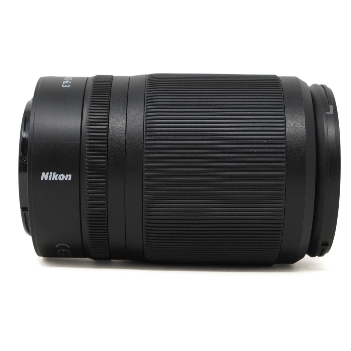 Black Nikon camera lens on a white background