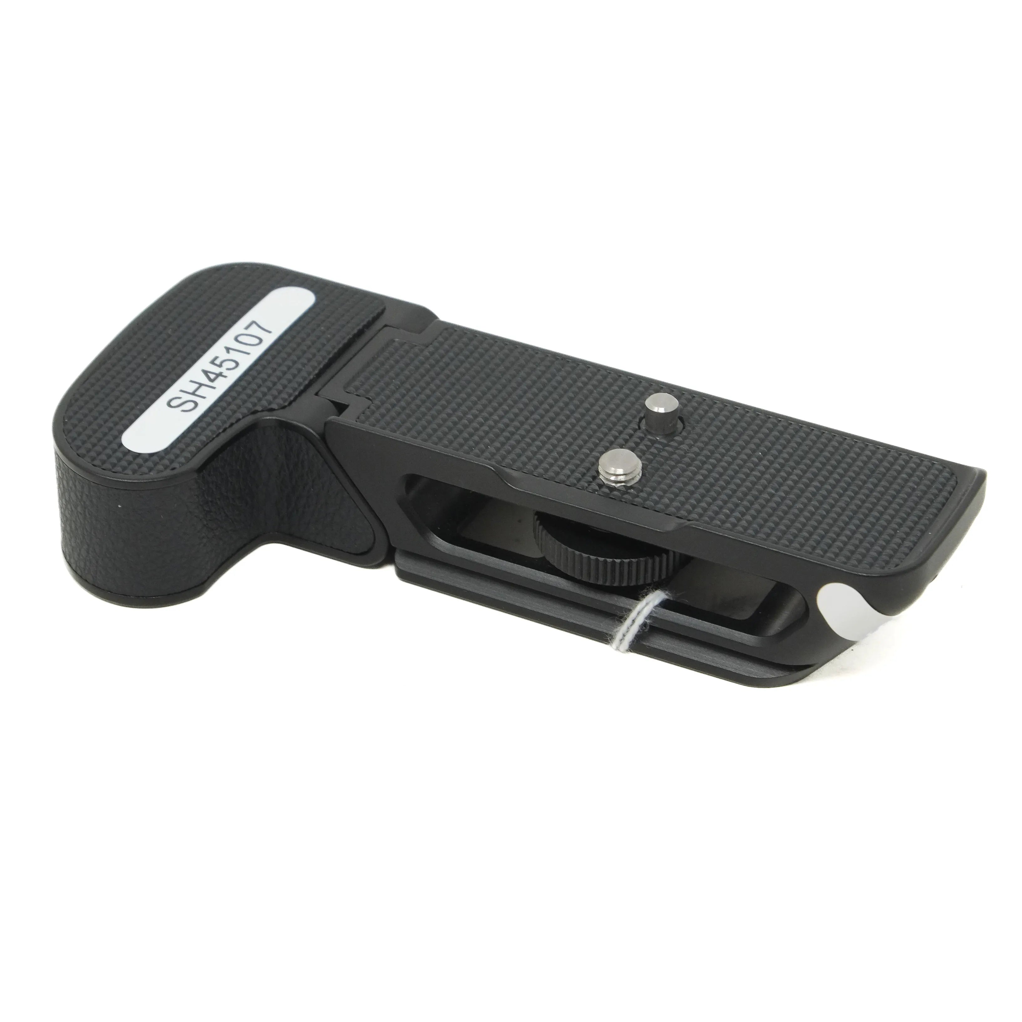 Black camera accessory with a white label on a white background