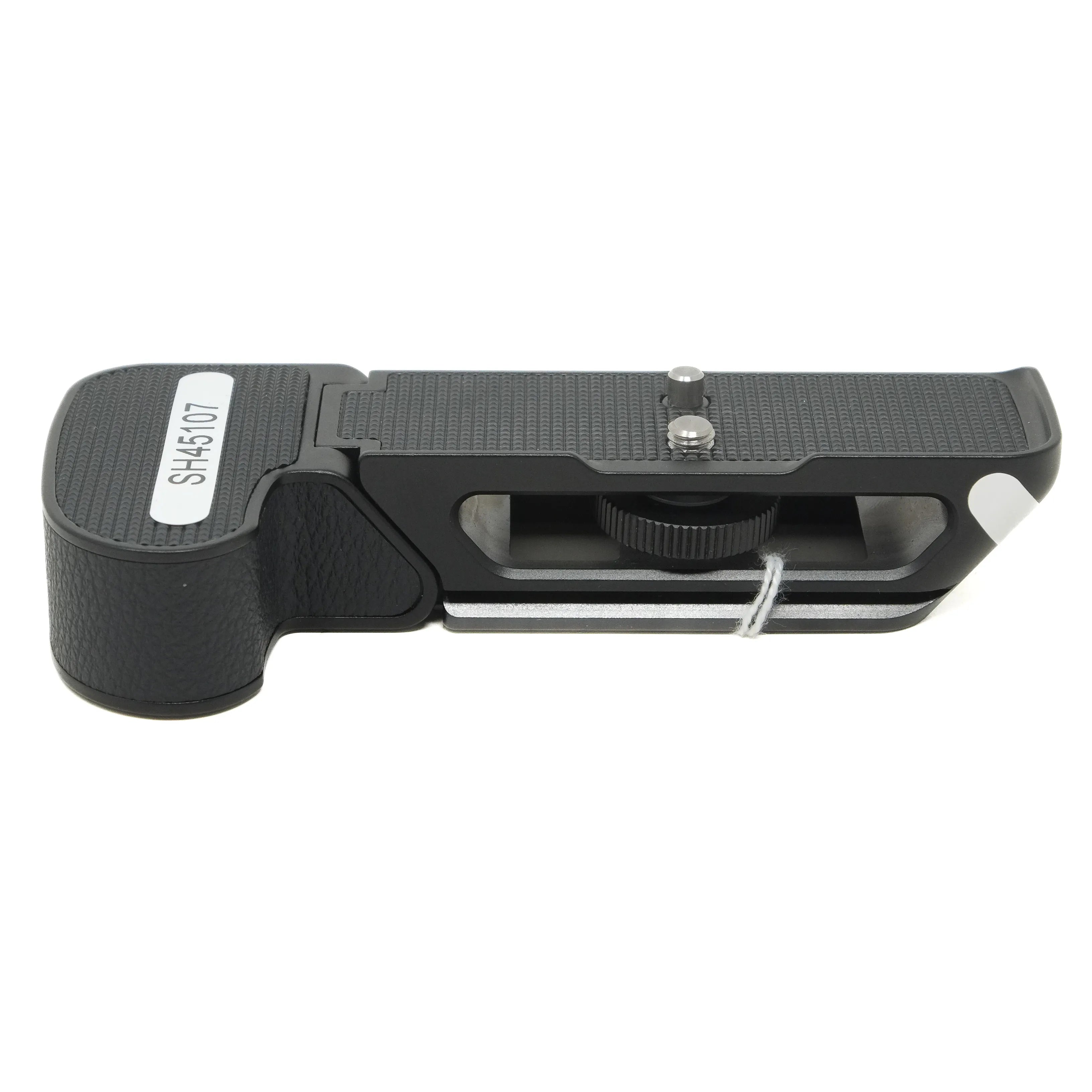 Black camera grip with a white label on a white background