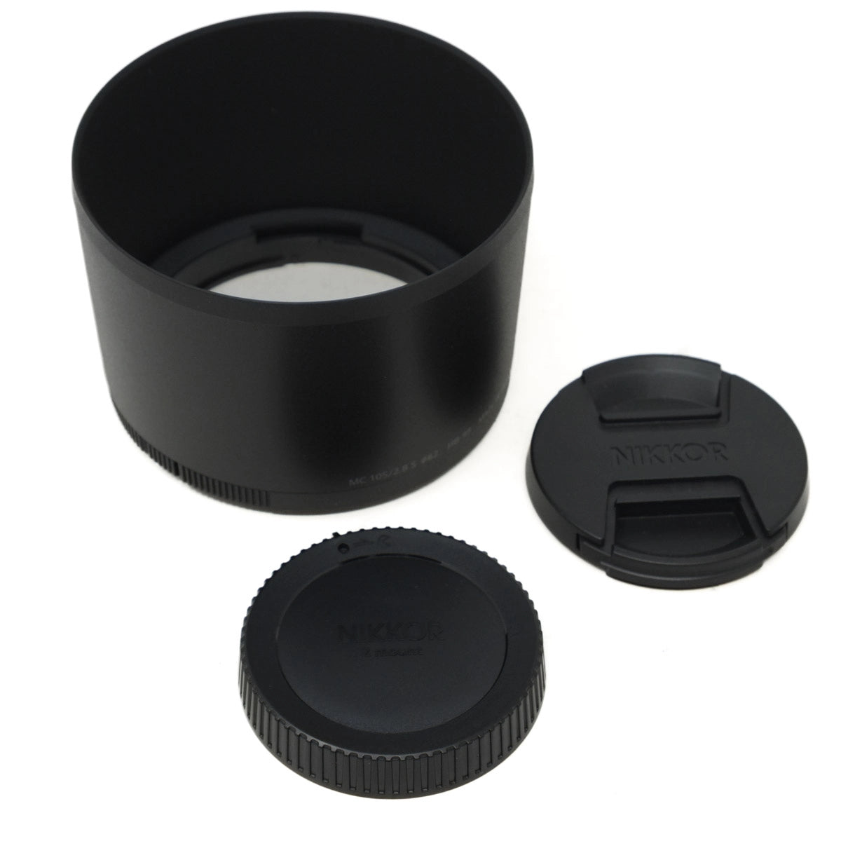 Black camera lens hood and caps on a white background