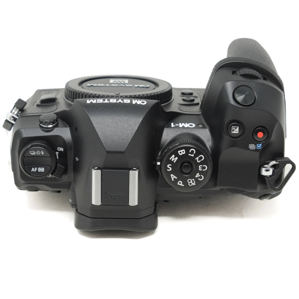 Top view of a black camera body on a white background