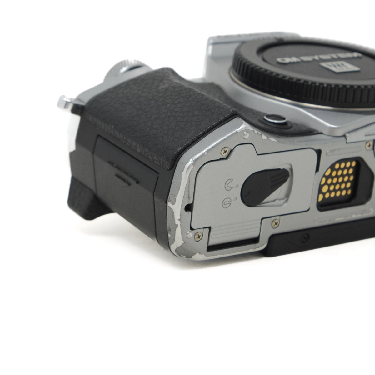 Close-up of a camera body with visible branding on a white background