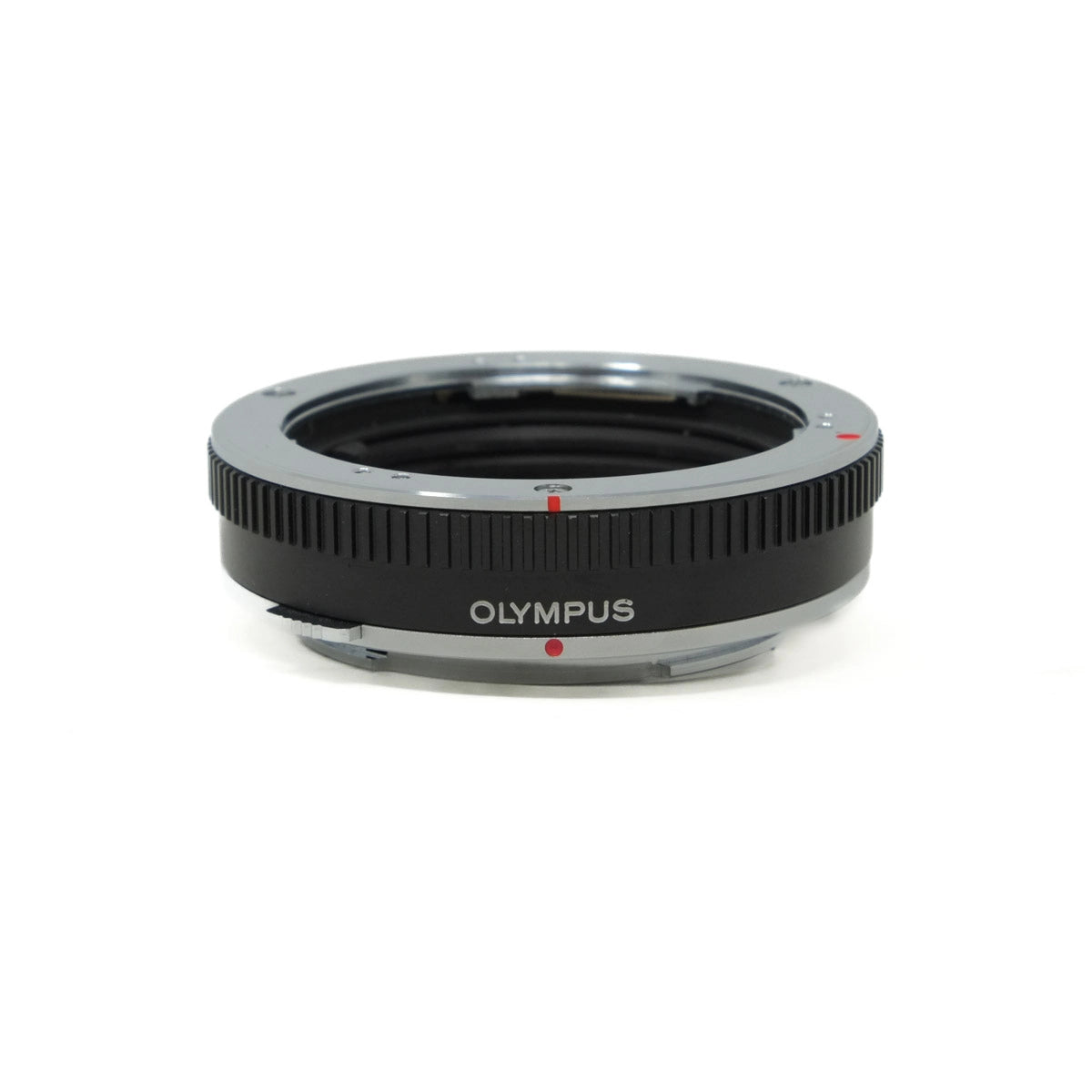 Olympus camera lens extension tube on a white background