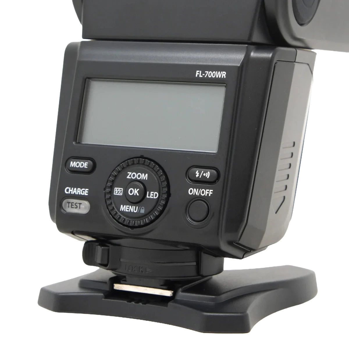 A close-up shot of a black Olympus FL-700WR camera flash modulator, showing the front control panel with a digital display screen, mode buttons, and a central rotary dial on a white background.