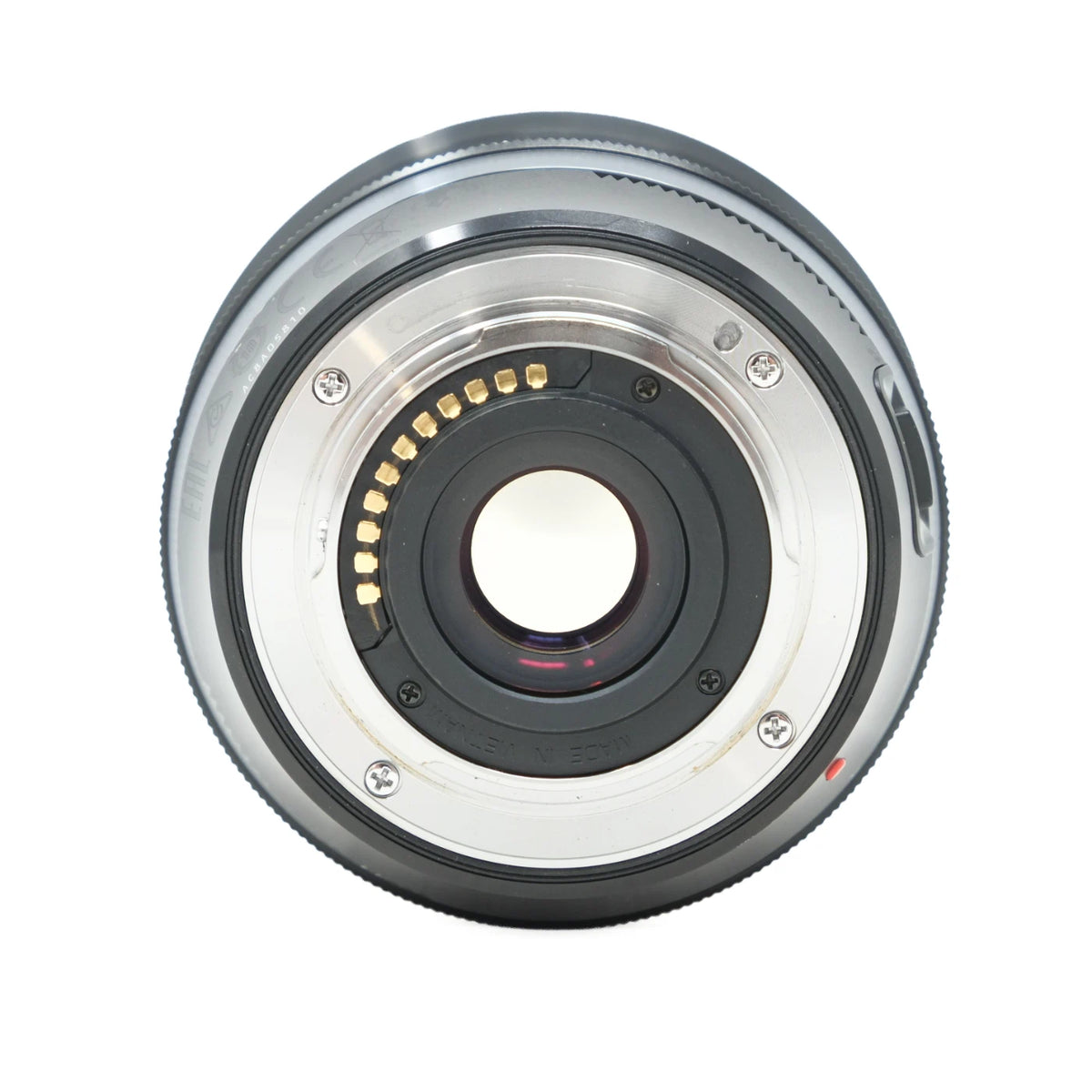 A close-up, top-down view of a camera lens rear mount, showing the metal ring, internal gold contact pins, and black rubber elements on a solid white background.