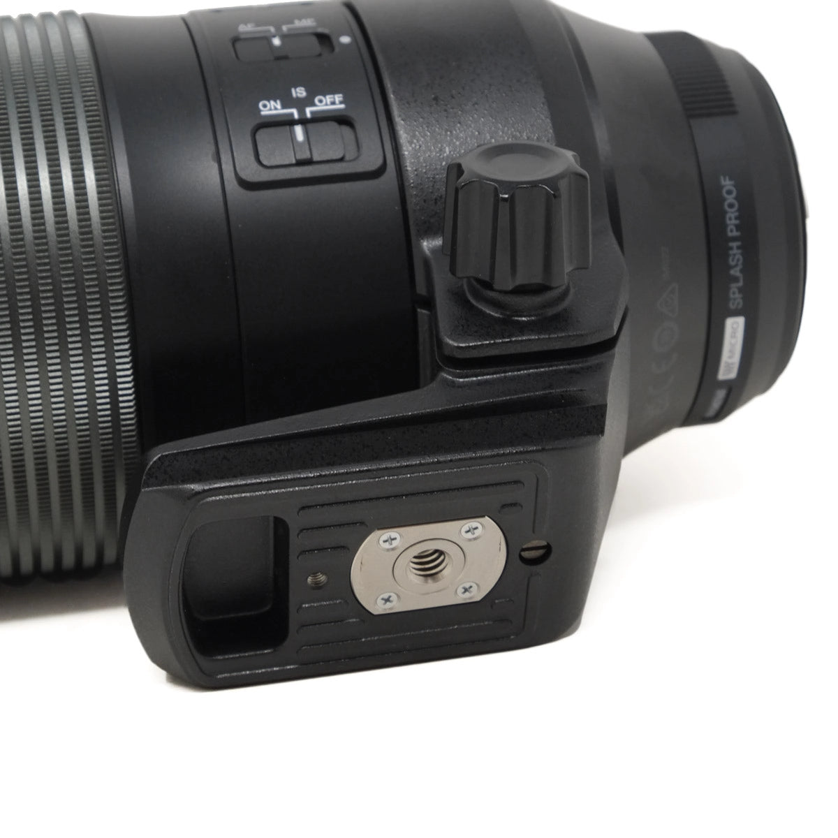 Close-up of a black camera lens and housing on a white background