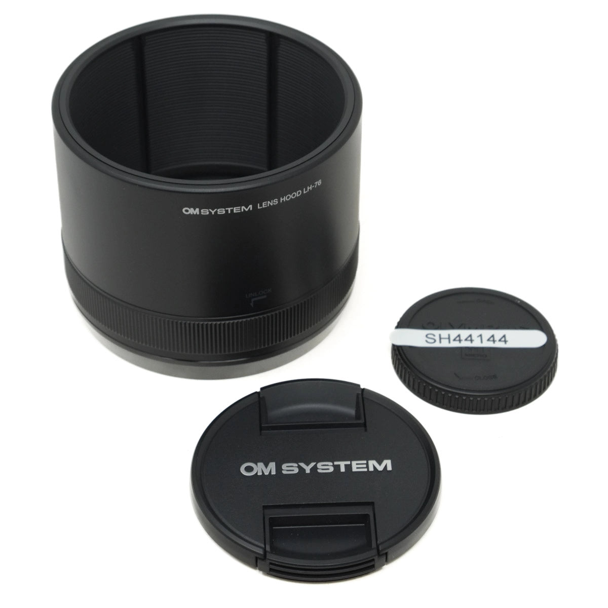 Black camera lens hood and cap with 'OM SYSTEM' branding on a white background