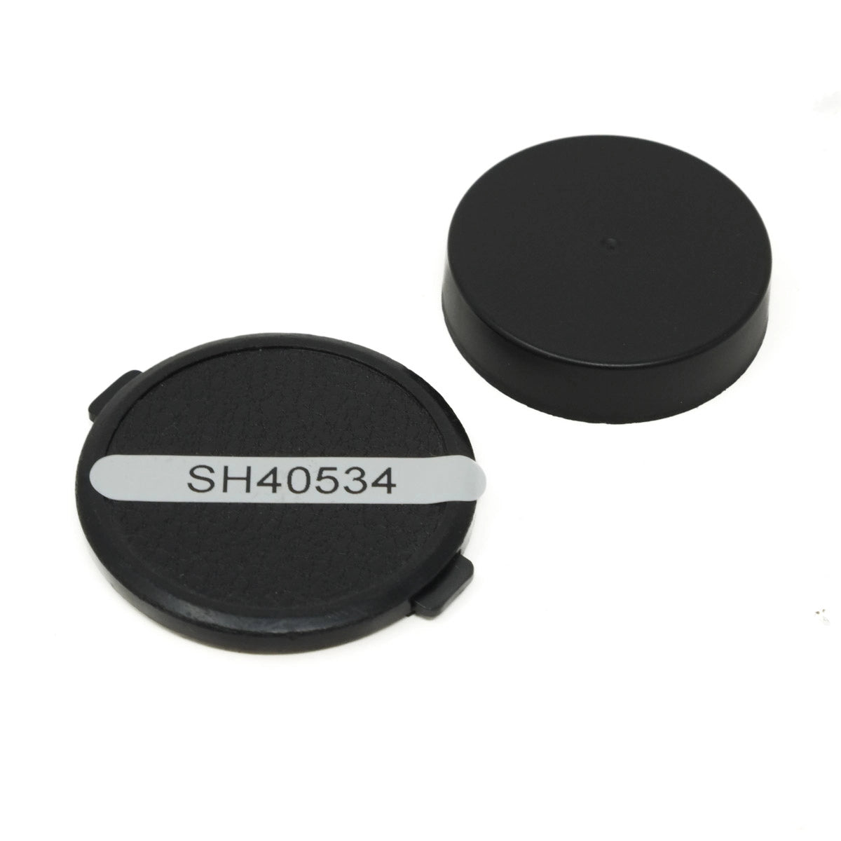 Two black lens caps with a label on a white background
