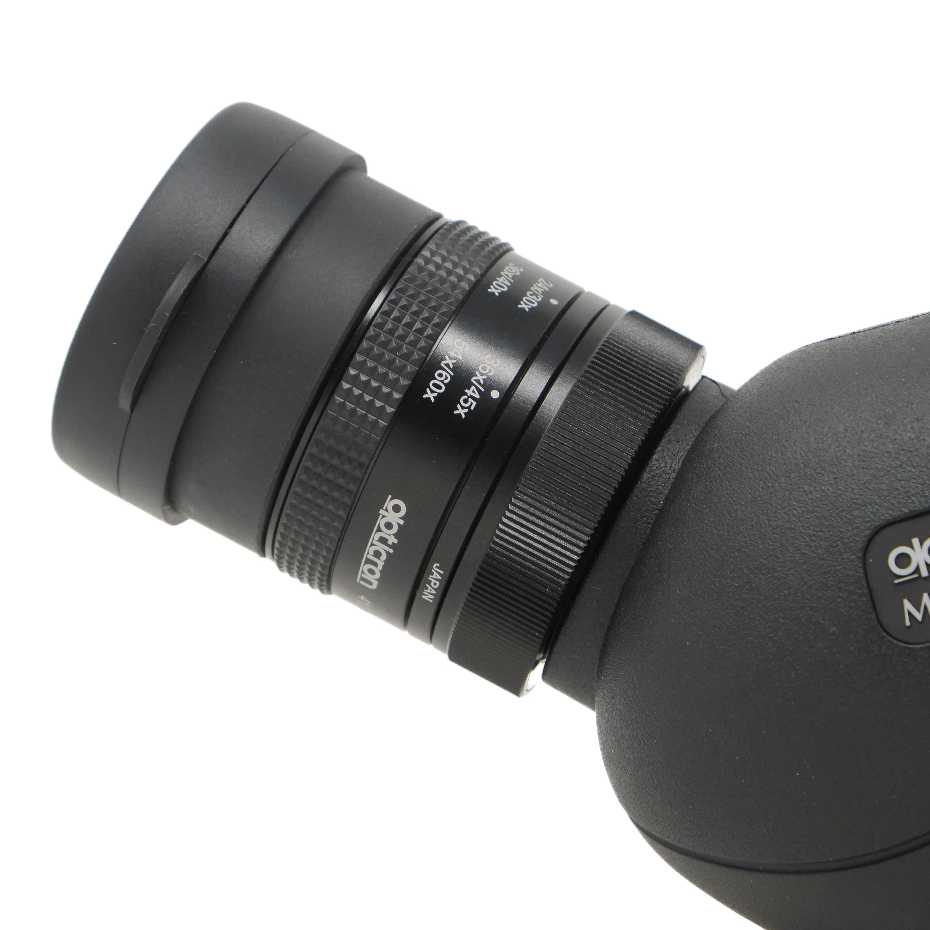 Close-up of a black telescope with focus control knobs on a white background