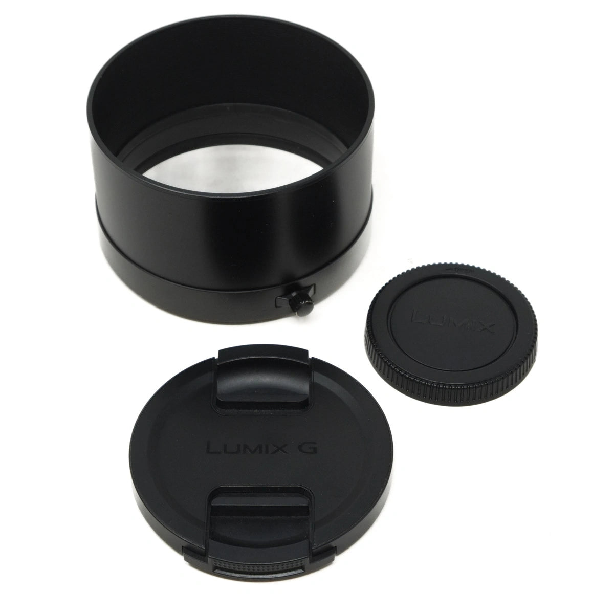 Camera lens hood and two lens caps on a white background
