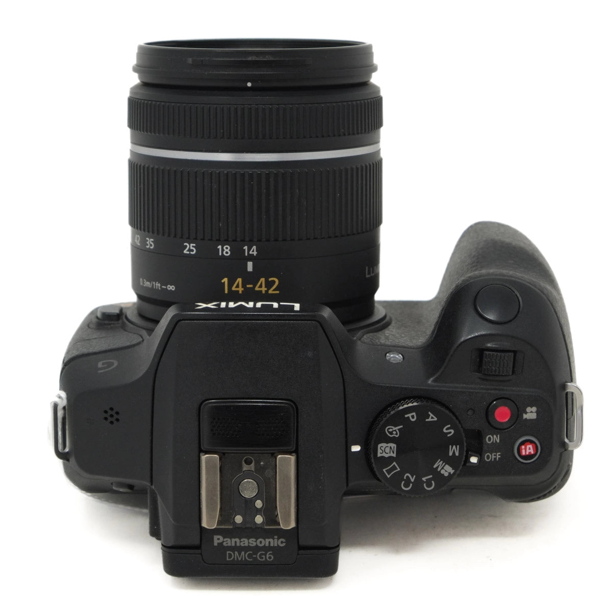 Black Panasonic camera with lens on a white background