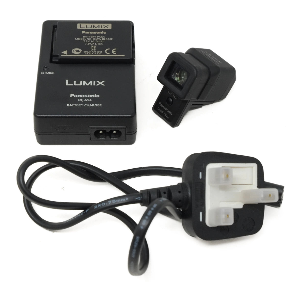 Panasonic Lumix battery, charger, EVF and plug adapter on a white background