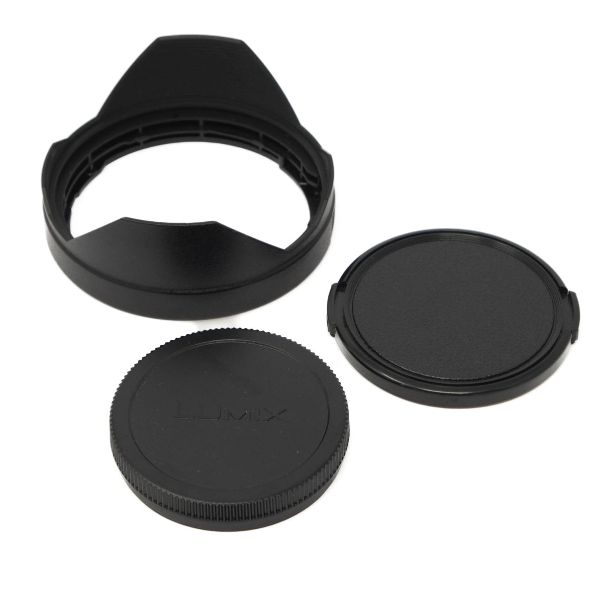Set of black camera lens caps and hood on a white background
