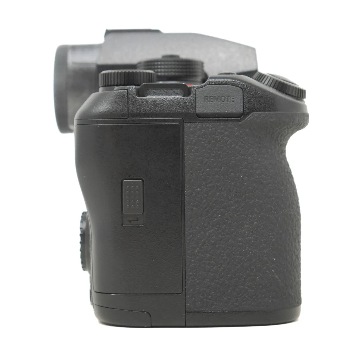 A close-up side view of a black camera body grip with textured controls and a remote button, shown against a plain white background.