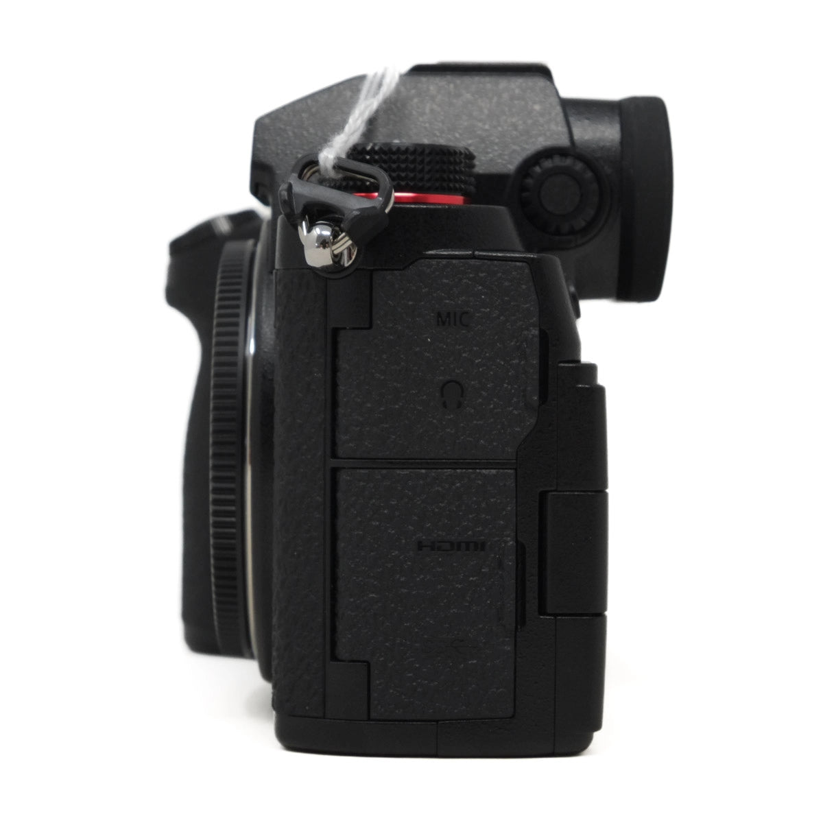 Black camera body with lens cap on a white background