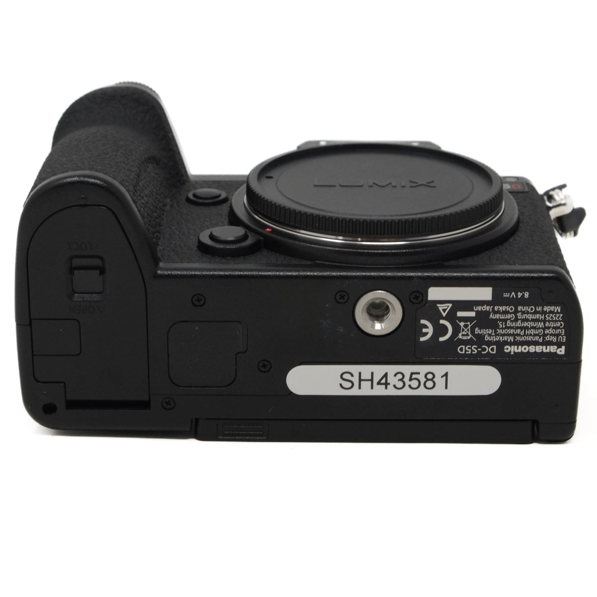 Bottom view of a Panasonic Lumix camera on a white background