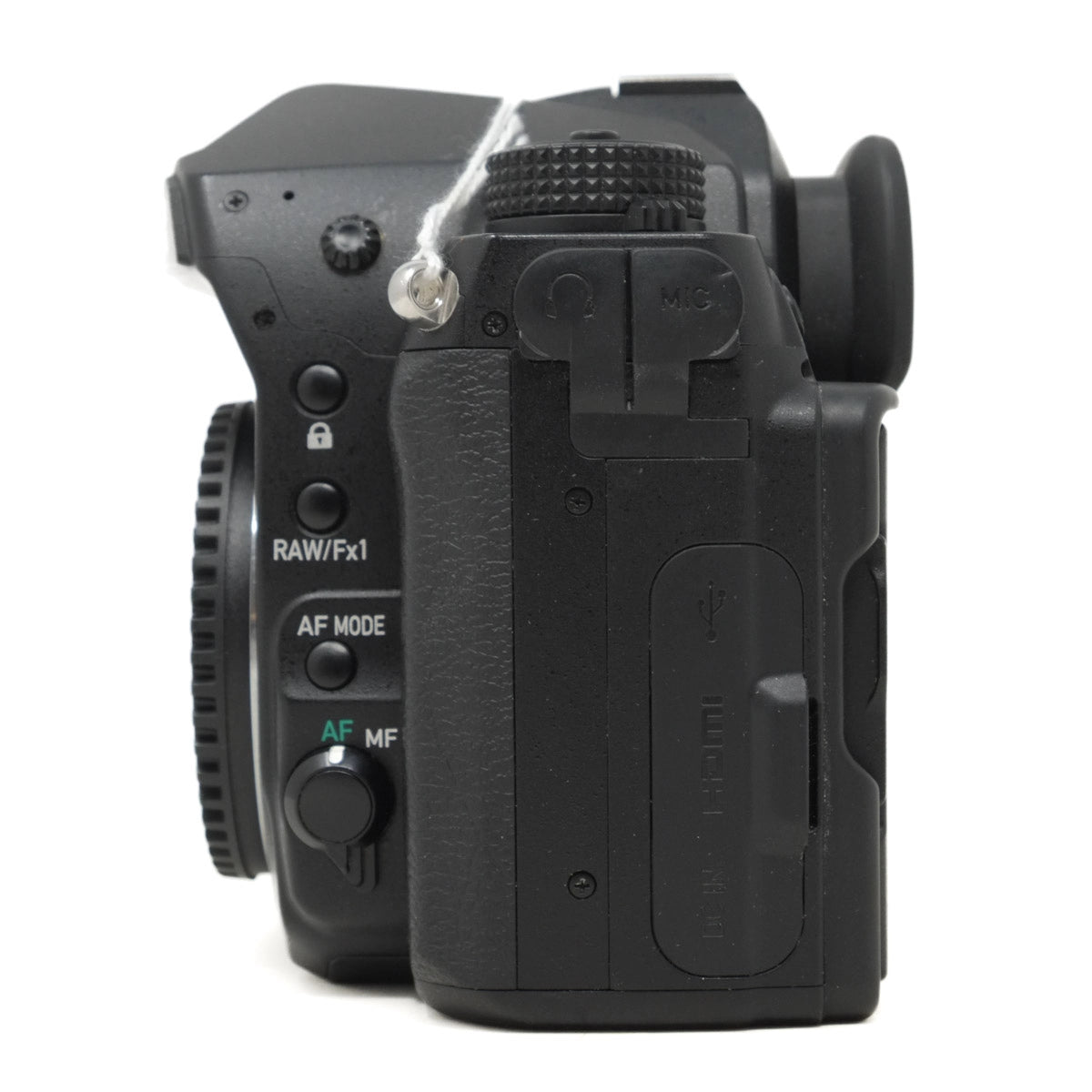 Black camera body with control dials on a white background