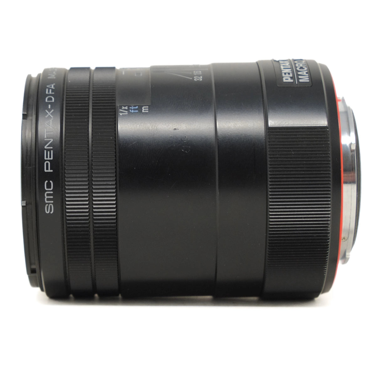 Camera lens with 'Pentax' branding on a white background