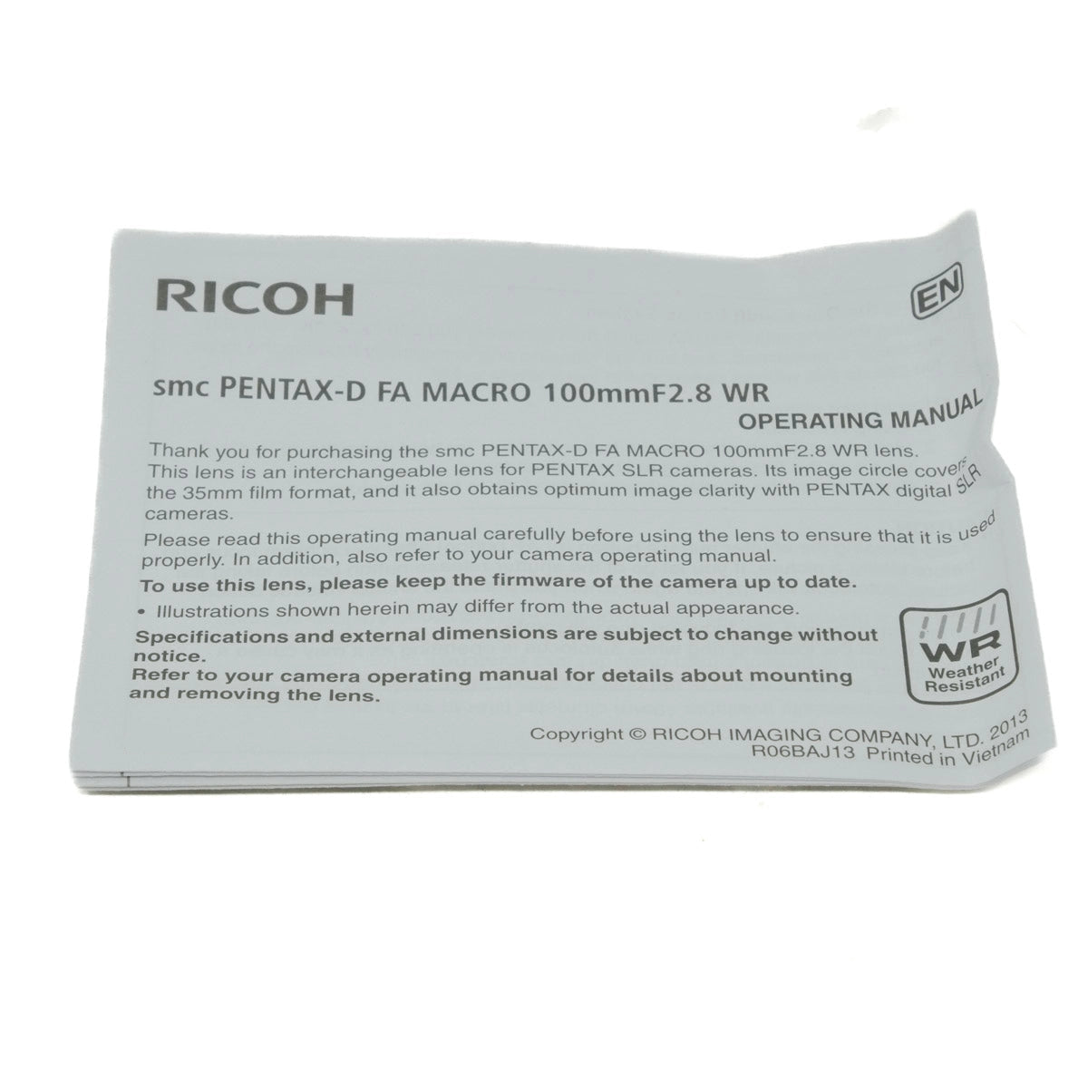 Ricoh Pentax-D FA Macro 100mm F2.8 WR lens operating manual packaging on a white background
