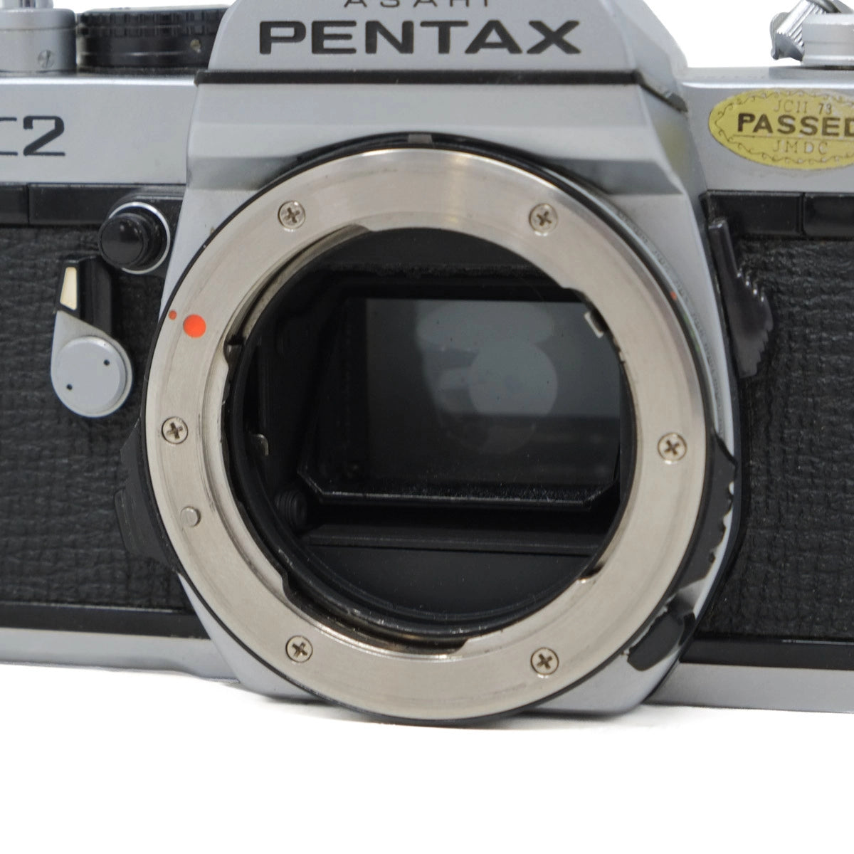 Close-up of a Pentax camera body on a white background