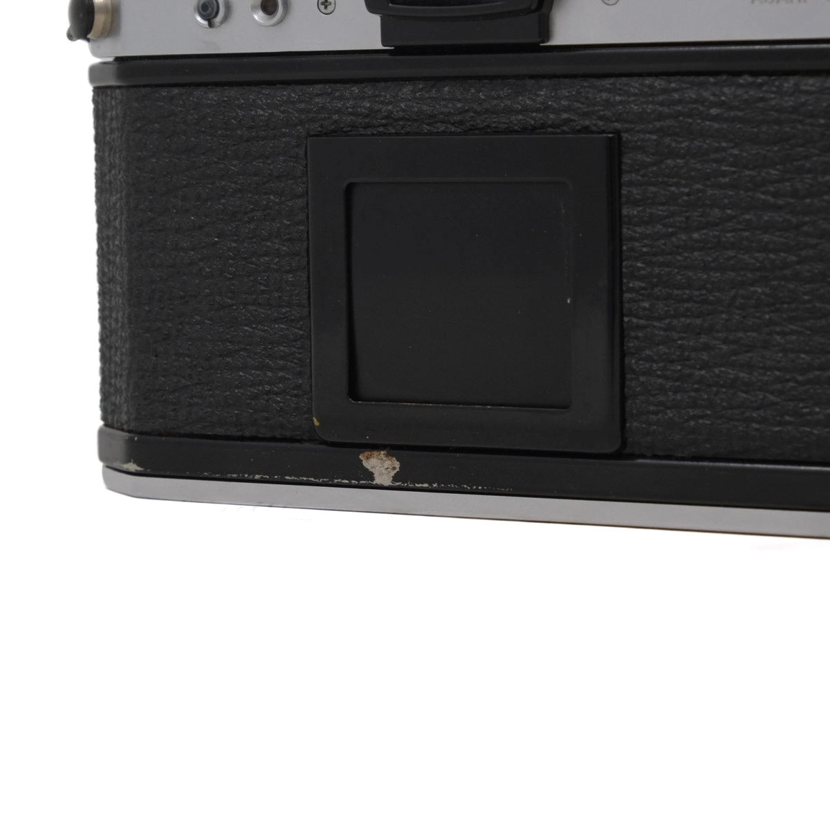 Close-up of a vintage camera with a textured black body and silver accents.