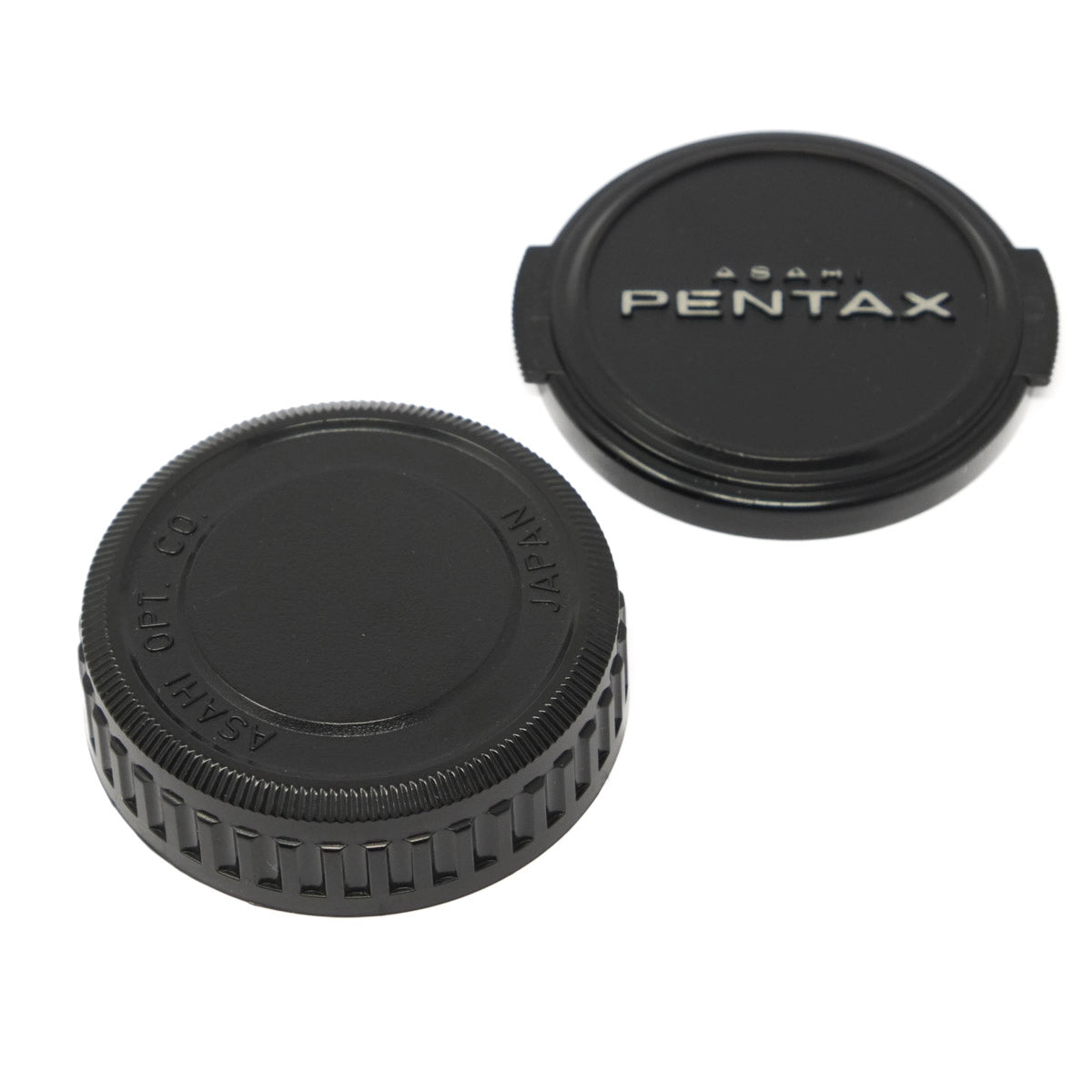 Two black camera lens caps with Pentax branding on a white background