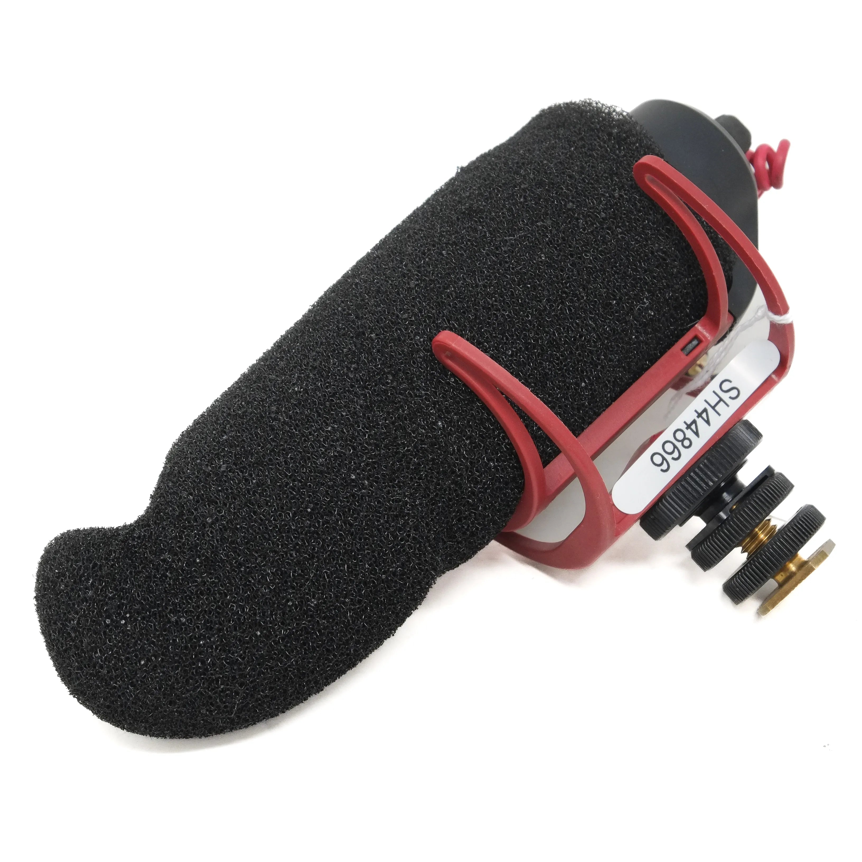 Red microphone with black foam cover on a white background
