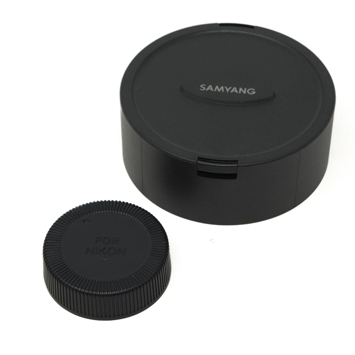 Two black camera lens caps with 'Samyang' and 'Nikon' branding on a white background