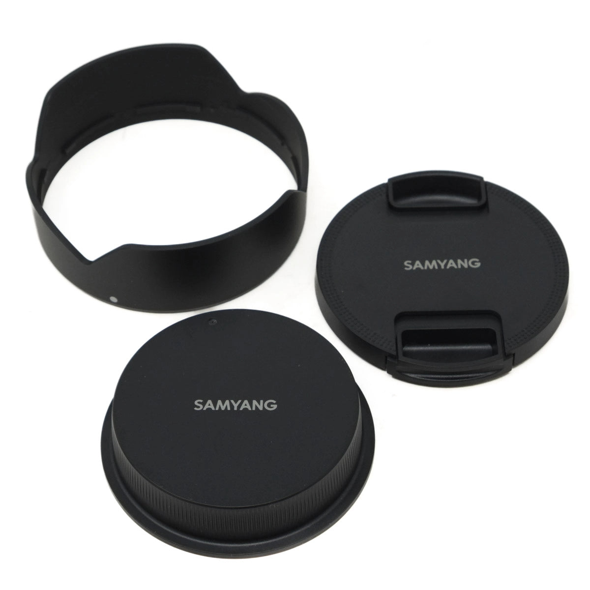 Three black camera lens caps with 'SAMYANG' branding on a white background