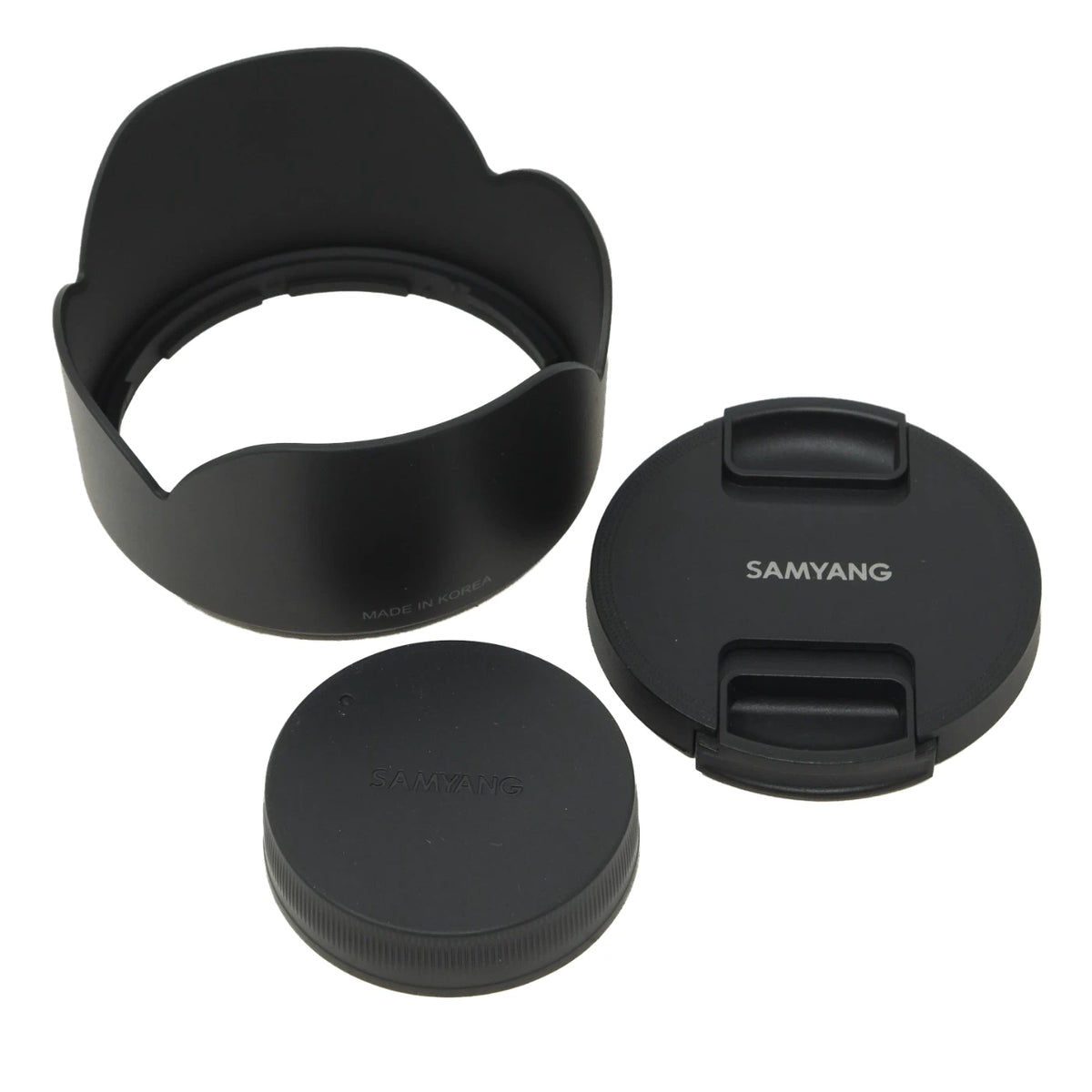 Black Samyang camera lens hood and lens caps on a clean white background.