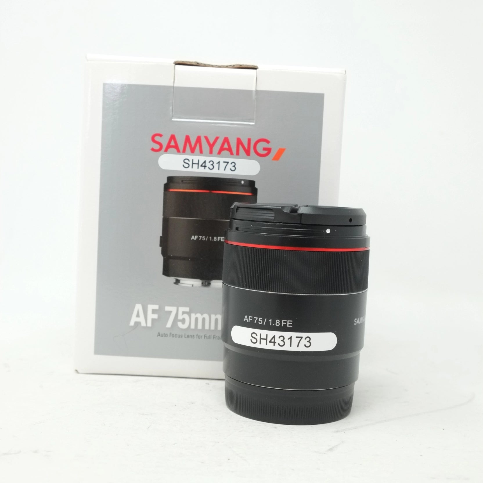 Samyang AF 75mm lens with packaging on a white background