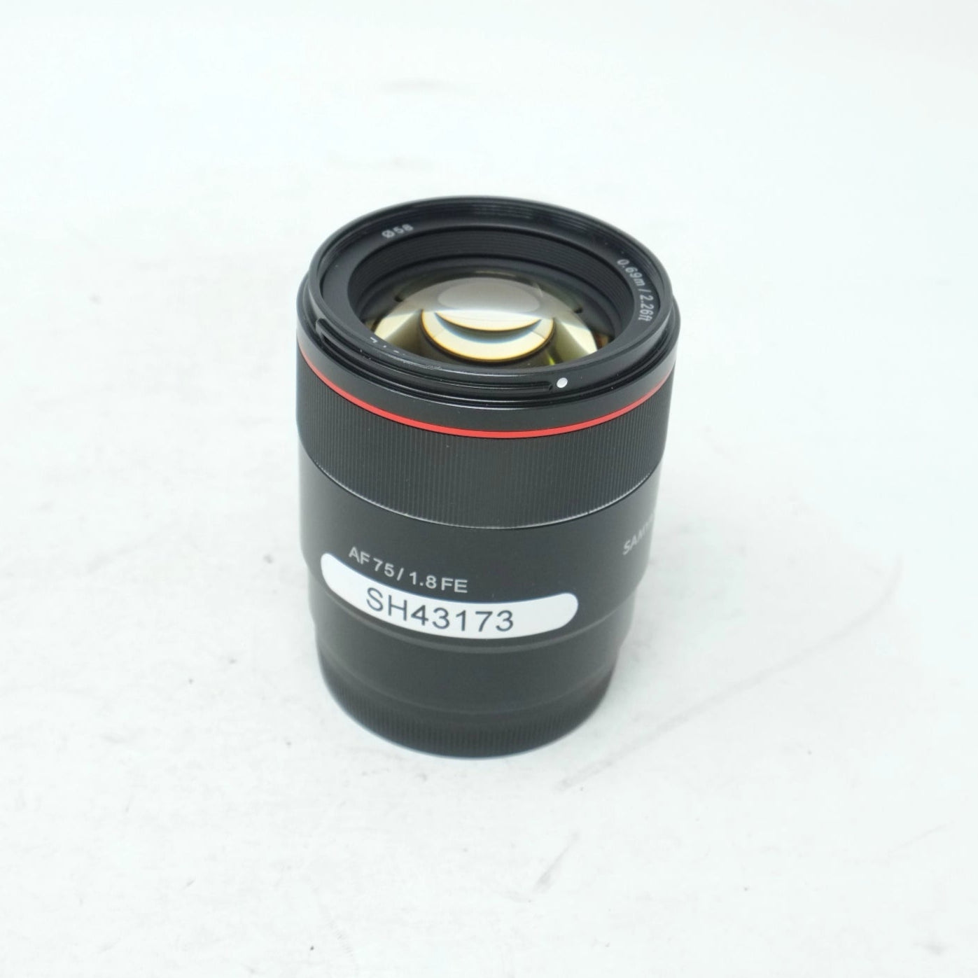 Camera lens with model number on a white background