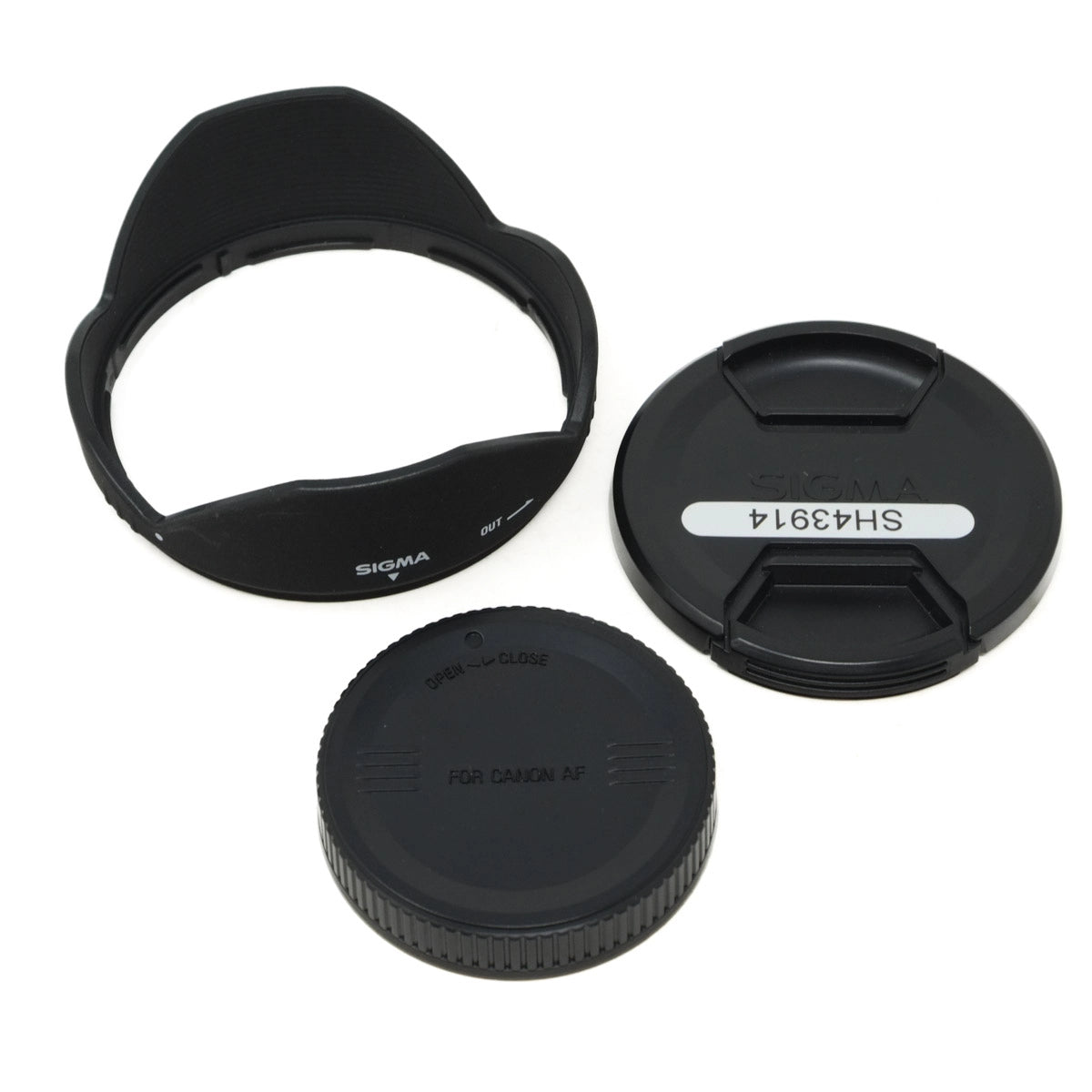 Camera lens accessories including a lens hood, front and rear caps on a white background