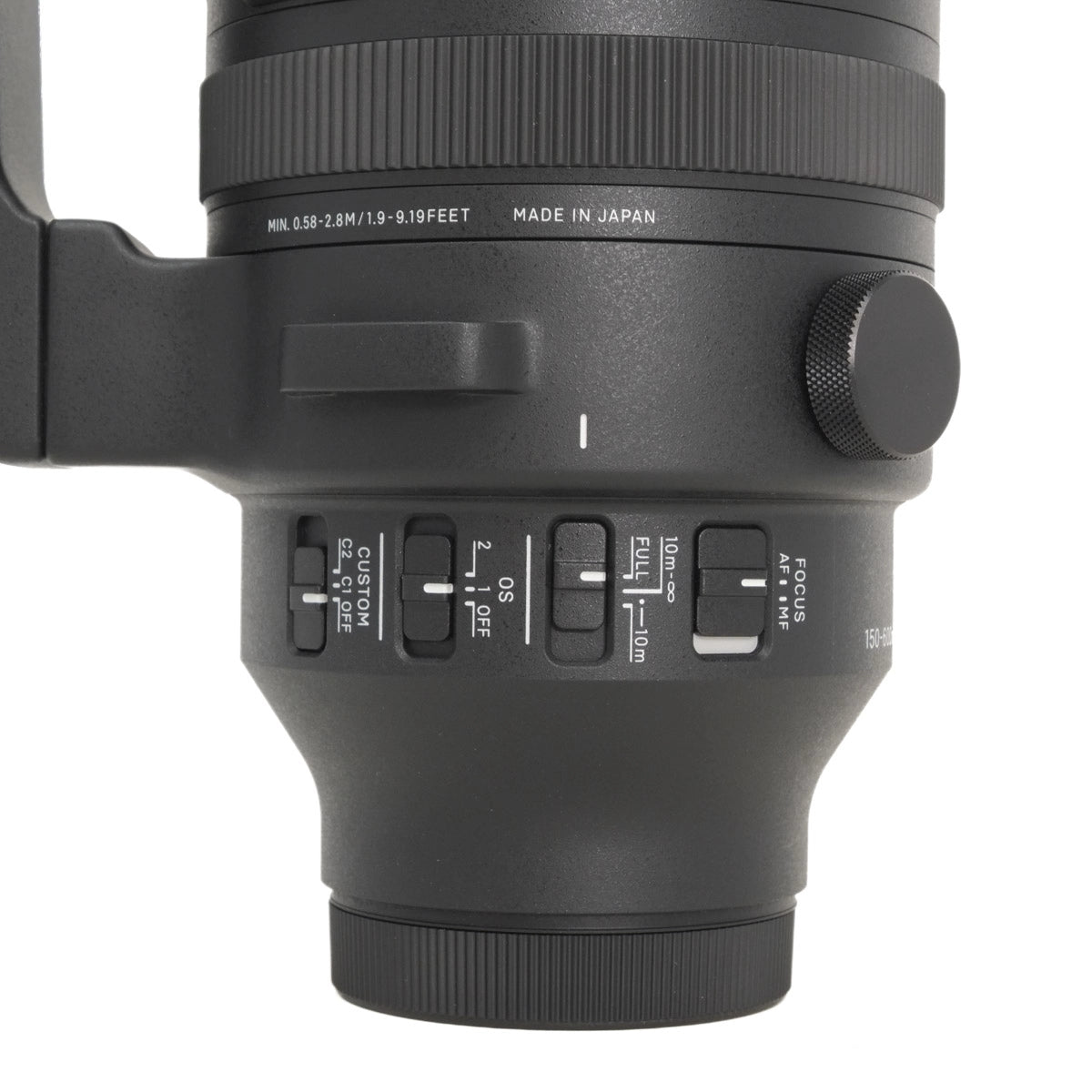 Close-up of a camera lens with control buttons on a white background