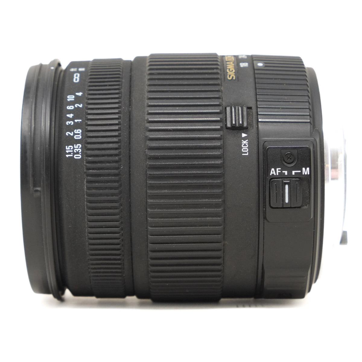 Camera lens with focus and mode switches on a white background